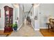 Hallway with an ornate clock, decorative niches, and tile floors, leading to various rooms in the house at 9220 Hidden Water Cir, Riverview, FL 33578