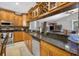 Kitchen showcases granite countertops, stainless steel appliances, and wooden cabinets with a wine rack at 9220 Hidden Water Cir, Riverview, FL 33578