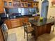 Kitchen featuring custom cabinets, granite countertops, and an island with breakfast bar at 9220 Hidden Water Cir, Riverview, FL 33578