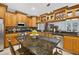 Spacious kitchen features granite countertops, stainless steel appliances, and ample wooden cabinets with a wine rack at 9220 Hidden Water Cir, Riverview, FL 33578