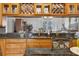 Spacious kitchen featuring granite counters, wood cabinets, and mirrored backsplash at 9220 Hidden Water Cir, Riverview, FL 33578