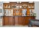 Kitchen with custom wood cabinets, built-in buffet with glass doors and an open serving area overlooking the living room at 9220 Hidden Water Cir, Riverview, FL 33578
