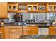 Gourmet kitchen featuring custom cabinets, granite counters, stainless steel appliances, and built-in wine storage at 9220 Hidden Water Cir, Riverview, FL 33578