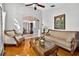 Inviting living room featuring an archway to the dining room, hardwood floors, and elegant furnishings at 9220 Hidden Water Cir, Riverview, FL 33578