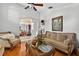 Comfortable living room with hardwood floors, neutral tones, and ornate details throughout at 9220 Hidden Water Cir, Riverview, FL 33578