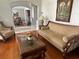 Cozy living room showcasing stylish furniture, hardwood floors, and a view into the dining area at 9220 Hidden Water Cir, Riverview, FL 33578