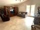 Relaxing living room featuring tile flooring, a sofa, tv, and sliding glass doors to the outside at 9220 Hidden Water Cir, Riverview, FL 33578