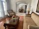 Well-lit living room with hardwood floors, classic furniture, and view to dining area at 9220 Hidden Water Cir, Riverview, FL 33578