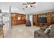 Open-concept living area with tile floors, custom built-ins, and views to kitchen at 9220 Hidden Water Cir, Riverview, FL 33578