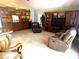Cozy living room featuring a large entertainment center, tile flooring, and comfortable seating at 9220 Hidden Water Cir, Riverview, FL 33578