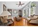 Comfortable living room with hardwood floors, high ceilings, and bright, natural light through arched windows at 9220 Hidden Water Cir, Riverview, FL 33578