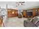 Bright open living area with tile flooring, custom cabinetry, a built-in bar, and an entertainment center at 9220 Hidden Water Cir, Riverview, FL 33578