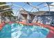 The screened-in pool area features a refreshing pool and a spacious patio for outdoor relaxation and entertainment at 9220 Hidden Water Cir, Riverview, FL 33578