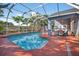 This screened-in pool provides the perfect spot for relaxation and recreation with mature landscaping and covered patio at 9220 Hidden Water Cir, Riverview, FL 33578