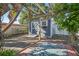 The backyard shed provides extra storage with a charming brick trim and lush greenery for privacy at 9220 Hidden Water Cir, Riverview, FL 33578