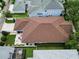 Aerial view showing the roof, backyard with a patio, and nearby homes at 10015 Brompton Dr, Tampa, FL 33626
