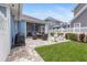 Well-manicured backyard featuring a grill, patio seating, and manicured lawn at 10015 Brompton Dr, Tampa, FL 33626