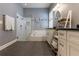 Bright bathroom featuring subway tile surround, soaking tub, and large glass enclosed shower at 10015 Brompton Dr, Tampa, FL 33626