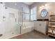 Bright bathroom featuring subway tile surround, soaking tub, and large glass enclosed shower at 10015 Brompton Dr, Tampa, FL 33626