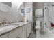 Bathroom featuring double sink vanity with granite countertops and tiled shower at 10015 Brompton Dr, Tampa, FL 33626