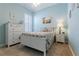 Bedroom with natural light, coastal decor, carpet, plantation shutters, and a white dresser at 10015 Brompton Dr, Tampa, FL 33626