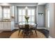 A bright dining area with a round table and chairs, situated by large windows at 10015 Brompton Dr, Tampa, FL 33626