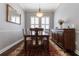 Formal dining room with elegant decor, chandelier, and hardwood floors for Gathering gatherings at 10015 Brompton Dr, Tampa, FL 33626