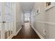 Long hallway featuring hardwood flooring and elegant wall decor leads to living areas at 10015 Brompton Dr, Tampa, FL 33626