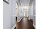 Spacious hallway featuring hardwood flooring, elegant trim, and natural light from the front door at 10015 Brompton Dr, Tampa, FL 33626