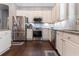 A stylish kitchen features white cabinets, stainless steel appliances, and granite countertops at 10015 Brompton Dr, Tampa, FL 33626
