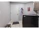 Well-organized laundry room with modern washer/dryer, storage, and convenient dog leash rack at 10015 Brompton Dr, Tampa, FL 33626