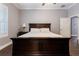 A cozy main bedroom features a dark wood bed frame, neutral walls, and an ensuite bathroom at 10015 Brompton Dr, Tampa, FL 33626