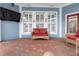 Covered patio featuring comfortable seating and red brick pavers, perfect for outdoor relaxation at 10015 Brompton Dr, Tampa, FL 33626