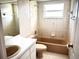 Neutral-toned bathroom featuring a bathtub, shower, and sink with mirror at 1039 Greenturf Rd, Spring Hill, FL 34608