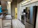 Contemporary kitchen with stainless steel appliances and a convenient layout with tile flooring at 1039 Greenturf Rd, Spring Hill, FL 34608