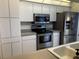 Bright kitchen featuring stainless steel appliances, ample storage, and modern finishes at 1039 Greenturf Rd, Spring Hill, FL 34608