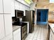 Modern kitchen with stainless steel appliances, tile flooring, and ample cabinet space at 1039 Greenturf Rd, Spring Hill, FL 34608
