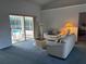 Comfortable living area with sliding doors to a screened pool, perfect for indoor-outdoor living at 1039 Greenturf Rd, Spring Hill, FL 34608