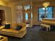 Living room featuring a sofa, piano, chandelier, and view into the front entrance at 1039 Greenturf Rd, Spring Hill, FL 34608