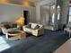 Living room with seating area and views to the front entrance at 1039 Greenturf Rd, Spring Hill, FL 34608