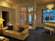 Living room featuring a sofa, piano, chandelier, and view into the front entrance at 1039 Greenturf Rd, Spring Hill, FL 34608