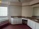 Main bath featuring a tub, double sinks, vanity area with a stool, and carpet at 1039 Greenturf Rd, Spring Hill, FL 34608