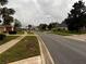 A quiet residential street lined with mature trees and well-maintained lawns at 1039 Greenturf Rd, Spring Hill, FL 34608