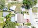 Aerial view of a property featuring a pool, a large backyard, and ample parking space with two cars at 11996 117Th St, Seminole, FL 33778