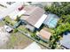 Aerial view of the backyard featuring an enclosed pool, a shed, and a boat on a trailer secured behind a fence at 11996 117Th St, Seminole, FL 33778