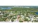 Aerial view of a neighborhood with mature trees and a lake nearby at 11996 117Th St, Seminole, FL 33778