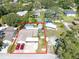 Aerial view of a home with a pool and a spacious, fully-fenced backyard, outlined in red for property boundary at 11996 117Th St, Seminole, FL 33778