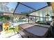 A covered outdoor spa, and an enclosed pool with a safety fence, offering fun and relaxation within a safe environment at 11996 117Th St, Seminole, FL 33778