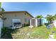 Backyard with a small shed and a larger shed, surrounded by a mix of greenery and open space at 11996 117Th St, Seminole, FL 33778