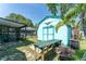 Backyard featuring a shed with a blue door and a workbench, ideal for outdoor projects and storage at 11996 117Th St, Seminole, FL 33778